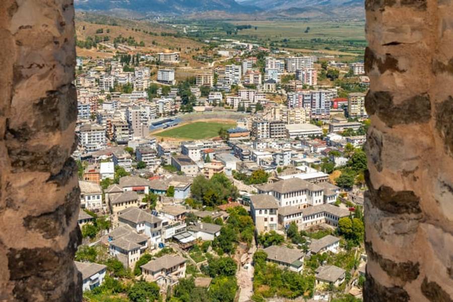 The stone rooftops of Gjirokaster seen through an Ottoman castle window, Albania