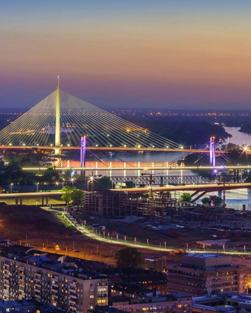 The Ada Bridge lit over the Sava river at dusk, Belgrade, Serbia