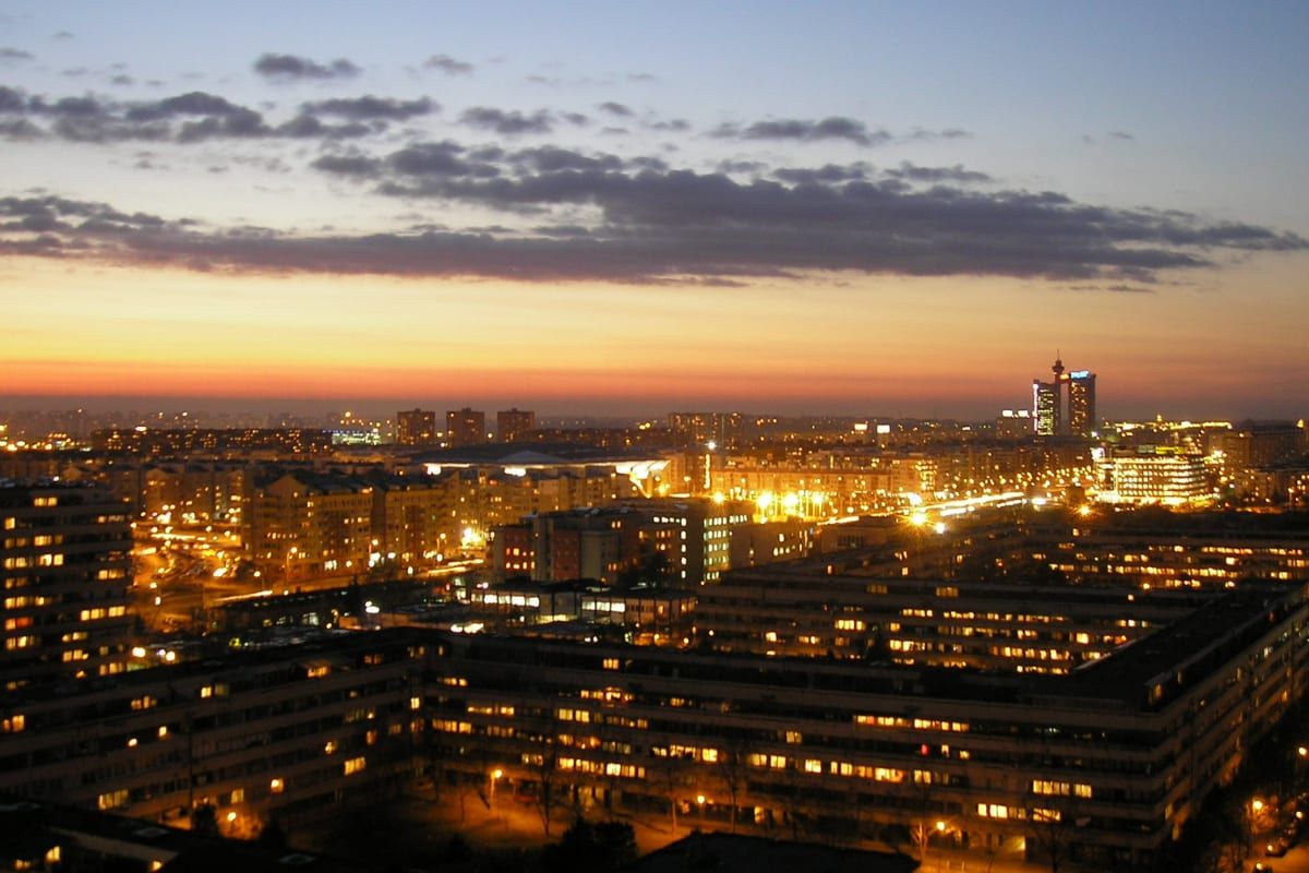 Novi Beograd's high-rise blocks and towers glowing at dusk across the New Belgrade skyline.