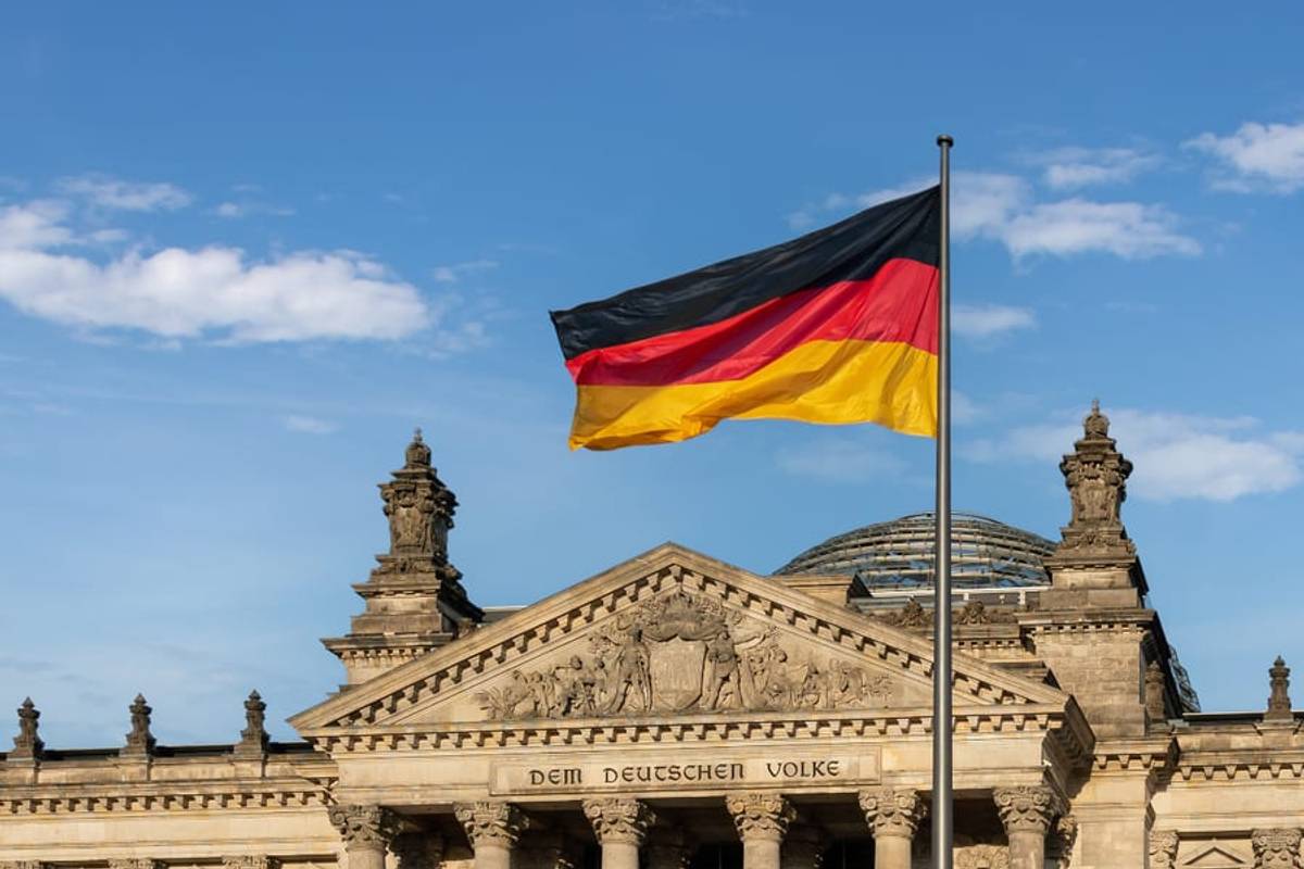 The German flag flying over the Reichstag building in Berlin, Germany