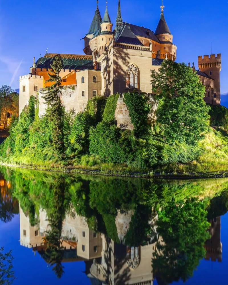 Bojnice Castle reflected in its lake at dusk, Slovakia