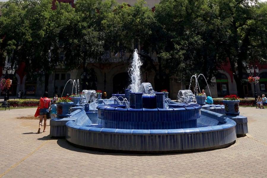 The blue-tiled Art Nouveau fountain on the main square on a sunny day, Subotica, Serbia