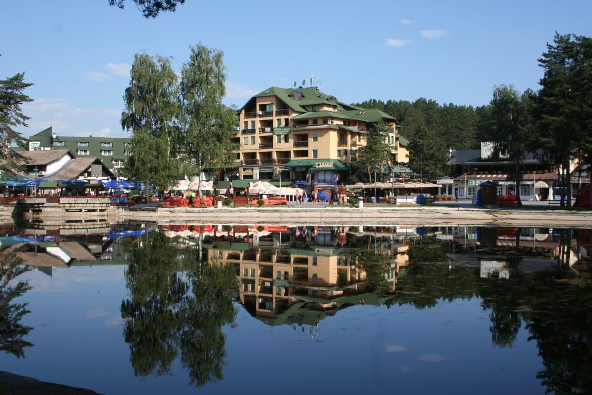 Zlatibor's central lake mirroring the promenade hotels and cafés at the heart of the resort.